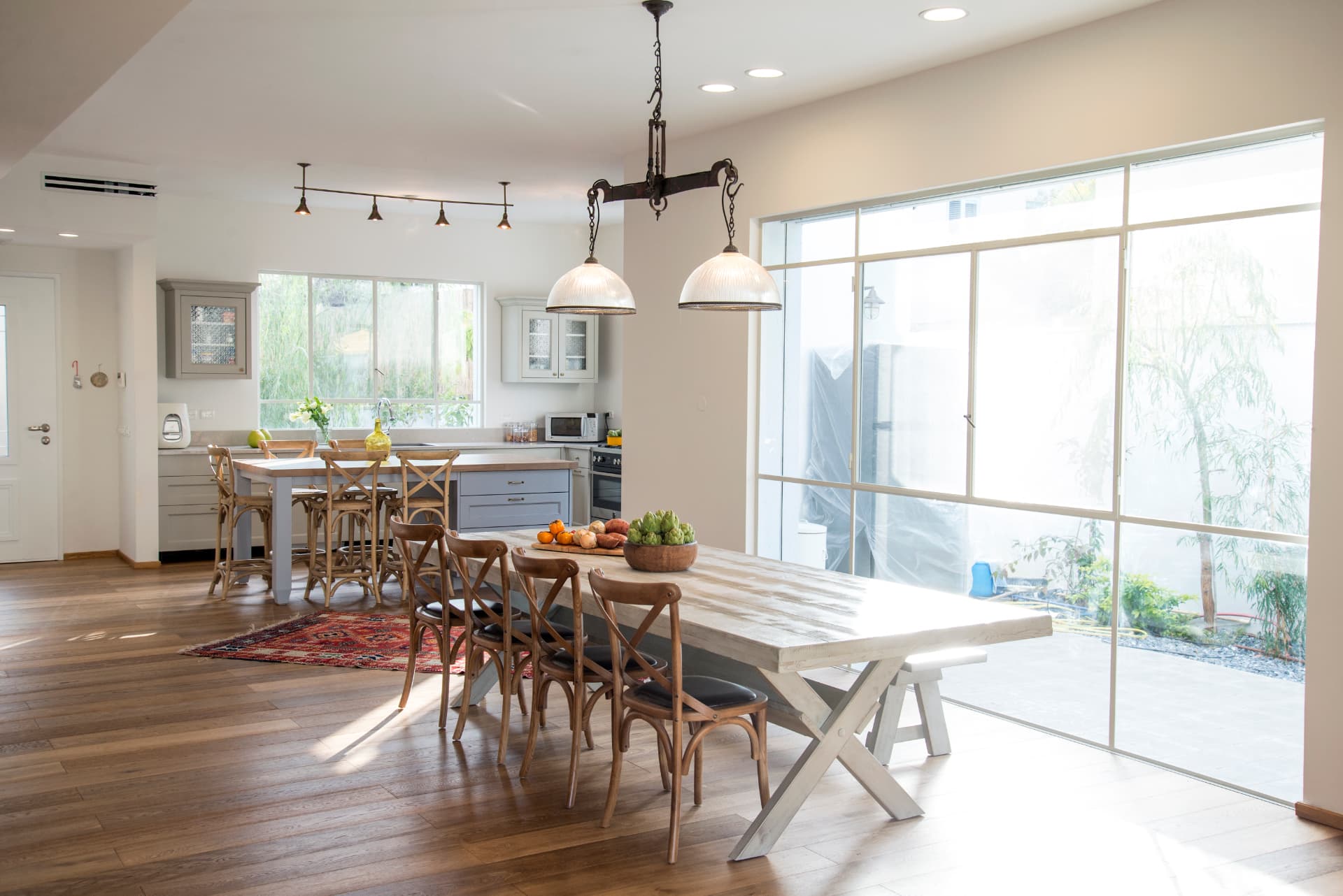 Open plan kitchen and dining space with pendant lighting and oak floors